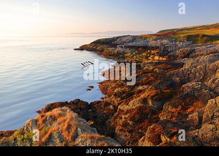 Vue de point Lynas en direction de Snowdonia au premier feu. Anglesey, pays de Galles du Nord, Royaume-Uni. Banque D'Images