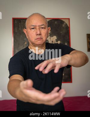 Un homme senior pratiquant les arts martiaux à l'intérieur. Banque D'Images