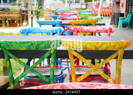 chaises vides colorées et table à l'extérieur Banque D'Images