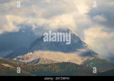 Faible angle de pic neigeux de Picos de Europa crête de montagne contre ciel nuageux en journée en Espagne Banque D'Images