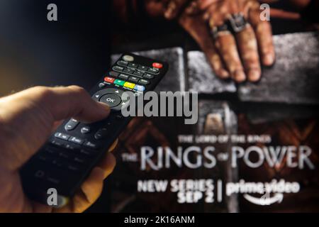 Belgrade, Serbie - 12 septembre 2022: Le Seigneur des anneaux: Les anneaux de puissance série TV à la télévision avec télécommande en main. Mise au point sur la télécommande suite Banque D'Images