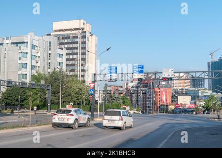 Pristina, Kosovo - June 5, 2022: Crossroads with traffic lights in capital of Kosovo. Stock Photo