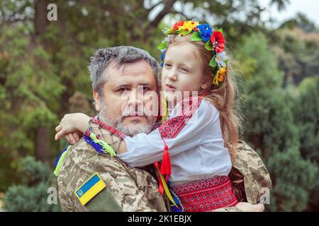 Portrait d'un soldat ukrainien avec sa petite fille. Réunion attendue depuis longtemps. Banque D'Images