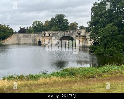 le pont du palais de blenheim au-dessus d'un lac à proximité des arbres Banque D'Images