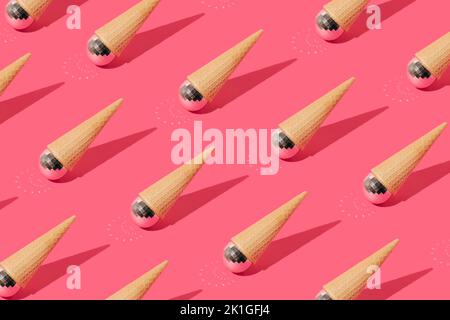 Summer pattern with ice cream cone and shiny disco ball turned upside down on pink background. Top view. Sharp shadow. Minimal concept Banque D'Images