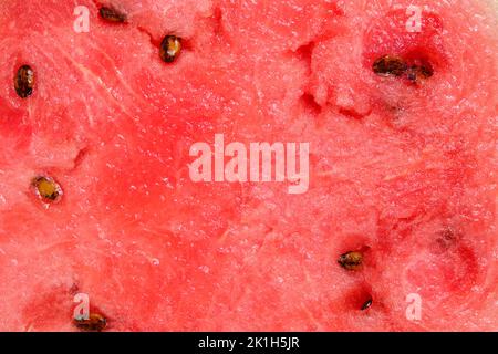Fond pulpe de pastèque rouge avec graines noires Banque D'Images