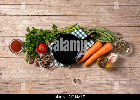 Assortiment de légumes, herbes et épices sur table en bois Banque D'Images