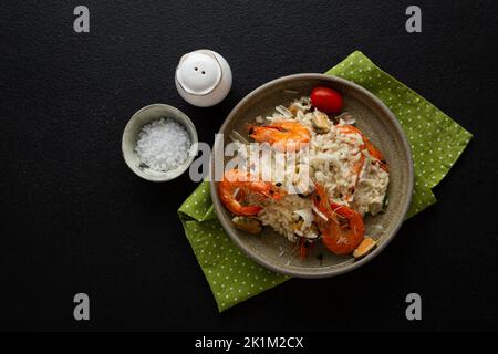 Risotto aux moules et au fromage de crevettes. Vue de dessus de la cuisine italienne sur une surface noire Banque D'Images