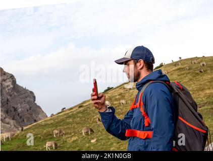 backpacker man takes a selfie in the mountains Stock Photo