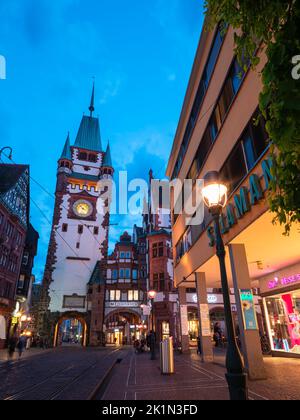 Freiburg im Breisgau, Allemagne - 13 avril 2022: Porte médiévale avec tour à Freiburg im Breisgau à l'heure bleue Banque D'Images