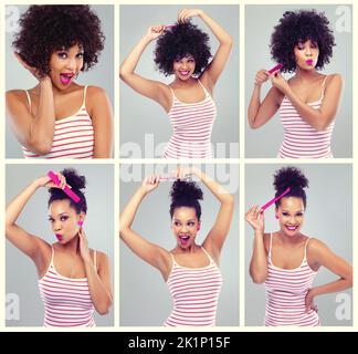 Coiffures ultra-stylistiques. Photo studio d'une jeune femme coiffant ses cheveux sur fond gris Banque D'Images