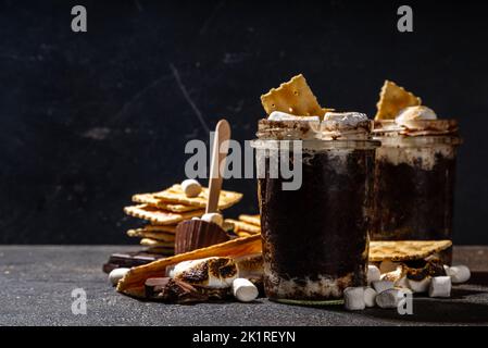 Chocolat noir smores mug gâteau dessert, recette simple rapide de cuisson au micro-ondes, gâteau de lave, brownie avec guimauves et biscuits graham dans un verre Banque D'Images