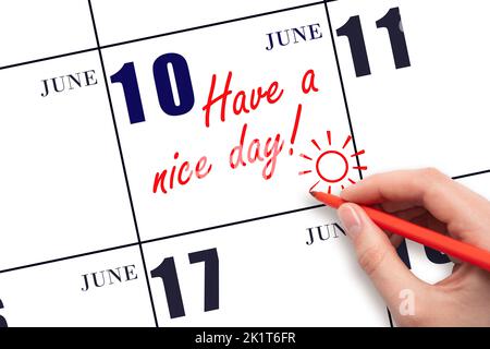 10th jour de juin. La main écrivant le texte ont une belle journée et dessinant le soleil sur la date calendrier 10 juin. Enregistrez la date. Mois d'été, jour du Banque D'Images