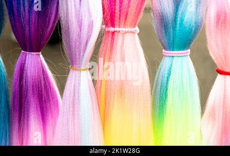 Cheveux synthétiques colorés. Fils de cheveux artificiels colorés à attacher et tresser les tresses en vacances. Banque D'Images