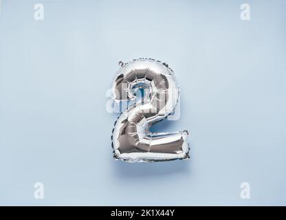 Silber ballon numéro 2 sur fond bleu clair pour votre nouvelle année de la fête d'anniversaire Banque D'Images