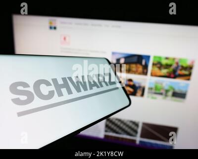 Smartphone avec le logo de la société allemande de détail Schwarz Group sur écran devant le site Web des entreprises. Mise au point à gauche de l'écran du téléphone. Banque D'Images