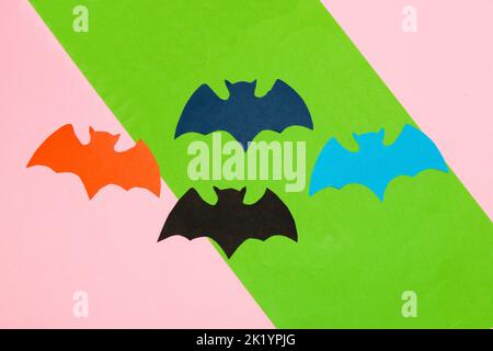 colorful bats on pink-green background, creative art design, halloween concept, flat lay, paper craft Stock Photo