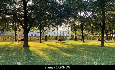 Park visitors on benches in the sunny Hofgarten Munich Stock Photo