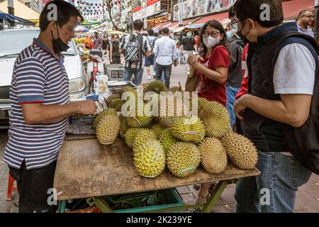 Malaysia, July 10, 2022 - Vendor sells durian smelly fruit. Stock Photo