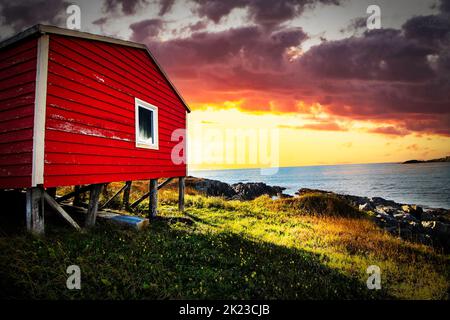 An old wooden fishing gear storage shed on the Atlantic Coast overlooking the water at Bonavista Newfoundland Canada at sunset. Stock Photo