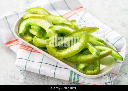 Dried pomelo slice on gray background. Dried fruit in sunlight. close up Stock Photo