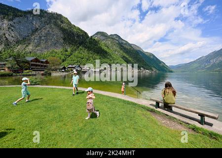 Mother with four children over Austrian alps lake in Hallstatt, Salzkammergut, Austria. Stock Photo