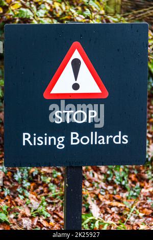 A sign warning motorists of rising bollards to control access Stock Photo