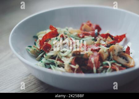 Zucchini pasta with mushrooms and chorizo Stock Photo