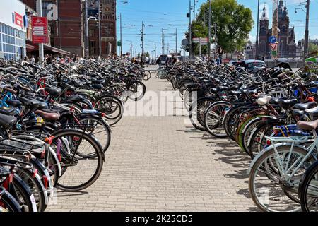 Amsterdam, Netherlands - August 2022: Rows of bicycles in bicycle racks left by commuters n the city centre Stock Photo