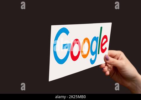 Kharkiv, Ukraine - June 05, 2020: Google icon. Internet search engine. Online promotion service. Woman hand showing browser lettering sign isolated on Stock Photo