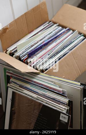 Old vinyl LP records stored in cardboard box Stock Photo