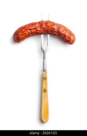 Saucisse fumée piquée sur une fourchette. Banque D'Images