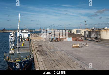 Europe, France, Dunkerque - July 9, 2022: Port scenery. Blue-white Challenger general cargo ship with its own cranes docked on quay 5 under blue cloud Stock Photo