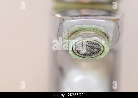 Ancien robinet à l'échelle comme manche en chrome calcifié dans la salle de bains a besoin d'entretien et de décalcification avec des agents de nettoyage pour arrêter les fuites et améliorer l'hygiène des bactéries de l'ancien manche avec la pauvreté de gouttelettes Banque D'Images