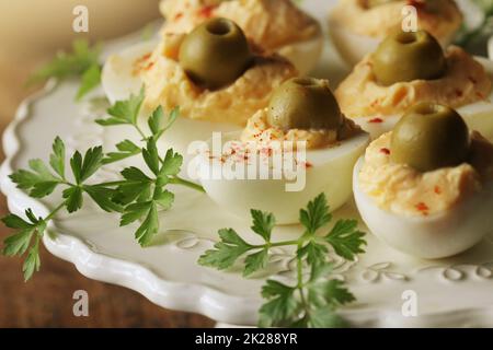 Oeufs farcis épicés garni d'olives vertes Banque D'Images