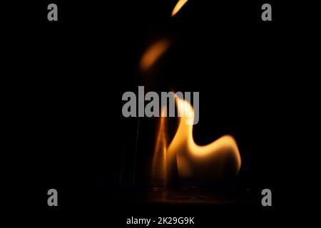 Flammes dans l'obscurité. Le feu est jaune sur fond noir. Banque D'Images