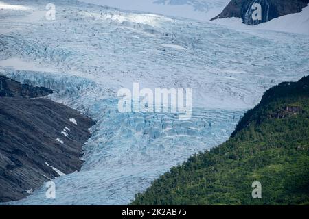 Wonderful landscapes in Norway. Nordland. Beautiful scenery of Svartisen glacier. Engabreen from the Holandsfjorden view. Mountains, trees, rocks and Stock Photo