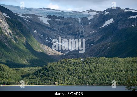 Wonderful landscapes in Norway. Nordland. Beautiful scenery of Svartisen glacier. Engabreen from the Holandsfjorden view. Mountains, trees, rocks and Stock Photo