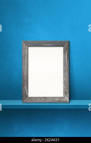 Cadre photo en bois appuyé sur une étagère bleue. 3d illustration. Arrière-plan vertical Banque D'Images