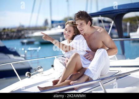 Cette vue est incroyable. Jeune couple s'amusant sur un yacht ensemble. Banque D'Images