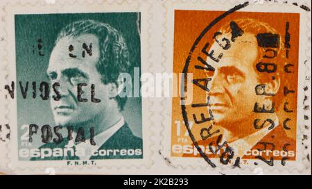 Photo of two Spanish postage stamps green 2 pesetas and orange 17 pesetas featuring an image of King Juan Carlos I Stock Photo