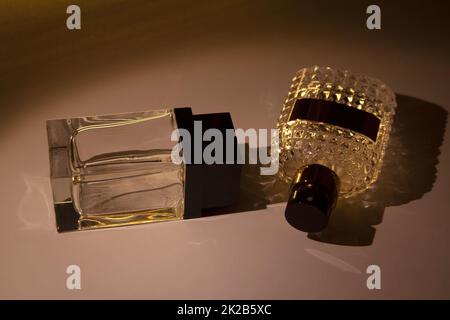 Two glass perfume bottles isolated in dark Stock Photo