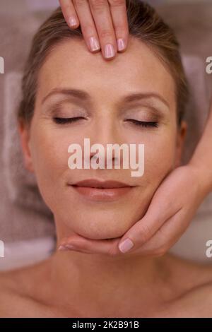 Tout simplement blasful. Photo courte d'une femme dans un spa de jour recevant un massage du visage. Banque D'Images