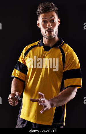 Mine is the last word. a referee against a black background. Stock Photo