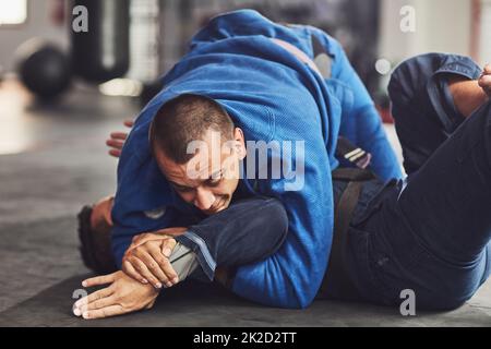 HES l'a épinglé. Coupe courte de deux combattants professionnels dans la salle de sport. Banque D'Images