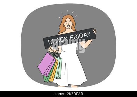 Bonne fille avec des sacs tenant la bannière noire de vendredi Banque D'Images
