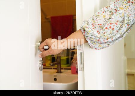 Asian woman patient use toilet bathroom handle security in nursing hospital ward, healthy strong medical concept. Stock Photo