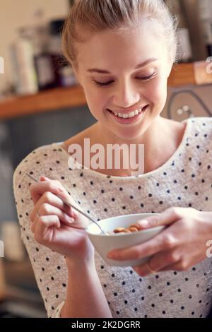 Healthy snacks- no guilt, just yum. a young woman eating a healthy snack at home. Stock Photo