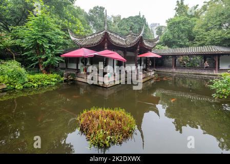 Traditional Chinese corridor and a pond in Chengdu people's park Stock Photo