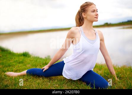 Le corps réalise ce que l'esprit croit. Photo d'une jeune femme faisant du yoga à l'extérieur. Banque D'Images